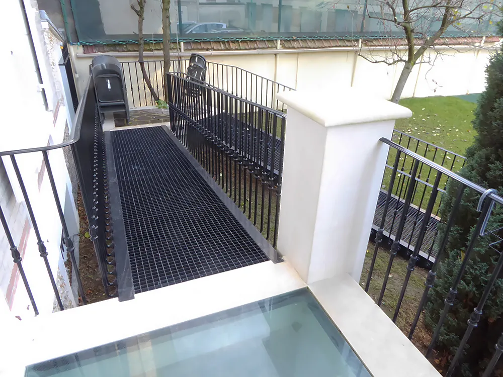 Porch of structural glass slabs to maximize light to basement area
